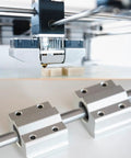 Two Pack 4mm By 100mm Linear Motion Rod Guide Shaft installed in a 3D printer with support blocks, case hardened chrome plated steel.