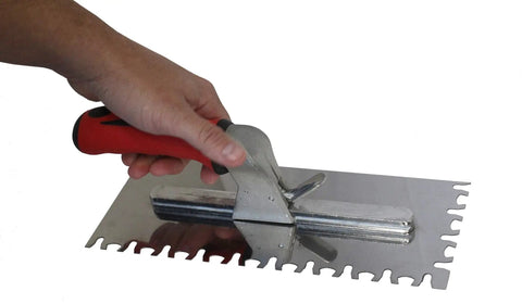 SwitchBlade Trowel Kit With Adjustable Handle And Comfort Grip in hand, showing rust resistant stainless steel blade with serrated edge