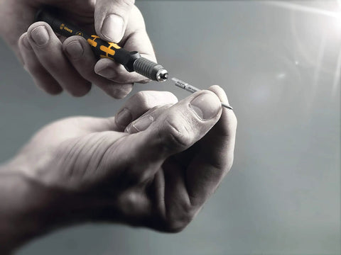 Hands using Micro Set ESD Twenty SB Bit Set With Quick Swap Handle, showing interchangeable blade system.