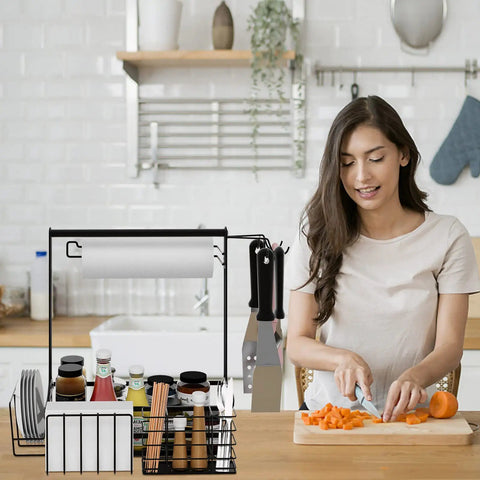 Woman chopping carrots next to Outdoor Grill Caddy With Paper Towel Holder And Utensil Organizer, ideal tailgate gear, in a kitchen.