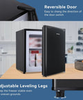 1.1 Cu Ft Upright Mini Freezer In Matte Black For Dorms And Small Bedrooms showing reversible door and adjustable leveling legs.