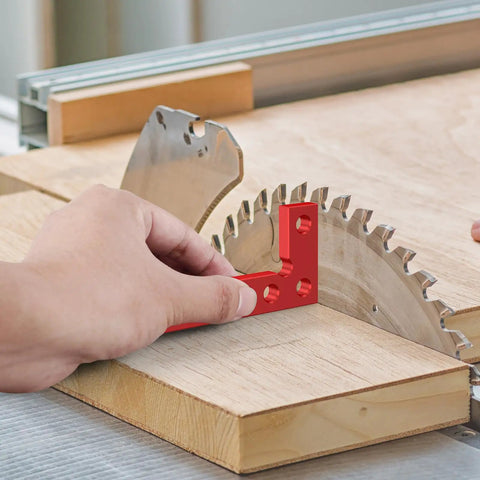 Pocket Sized EDC Precision Right Angle Square For Woodworking With Inch Scale CNC Aluminum Center Finder Tool Scriber And Edge Locator For Carpenters Red Finish used on edge of a wood panel and saw blade.