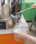Using stainless steel dripless honey bottling valve with 1 inch NPT thread on extractor for mess-free honey flow into a jar