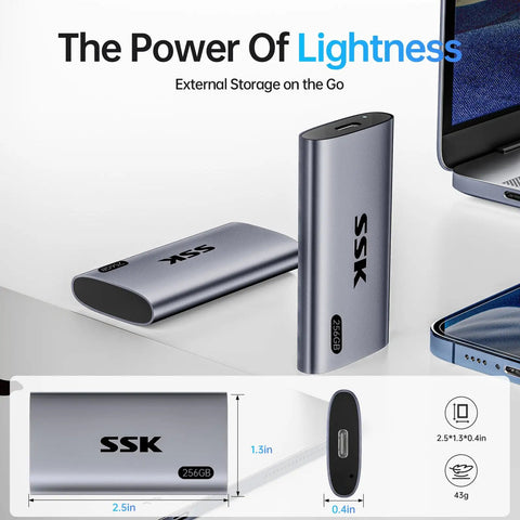 Image of a 256GB Portable SSD External Drive With Up To 550 MB Per Second USB 3.2 Gen2 For iPhone 15 Pro Windows Mac Android LED Indicator Trim And SMART Tech Ready next to a laptop.