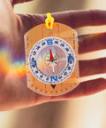 Hand holding Luminous Orienteering Compass With Ruler And Direction Pointer For Hiking And Camping Lightweight Outdoor Navigation Tool