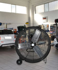 Beastly 30 Inch High Velocity Drum Fan With 13000 CFM High And 9000 CFM Low in an industrial garage setting
