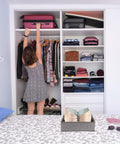 Slick Seven Compartment Folding Fabric Drawer Organizer For Underwear Socks And Hair Accessories To Quick Clean Up Your Bedroom Closet Space Without Any Sweat Or Hassle Today in a closet with folded clothes and bags.