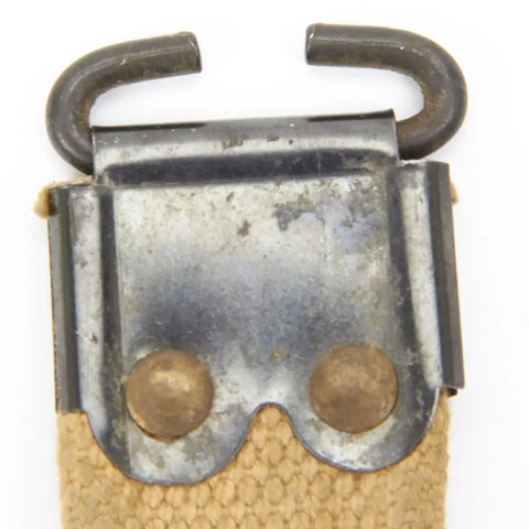 Close-up of steel fittings on WWII British Enfield Web Khaki Sling with steel fittings authentic dated military gear for SMLE rifles.