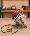 Heavy Duty Transmission Servo Cover Actuator Assembly with red cover, black rubber seals, and springs on a metallic surface.