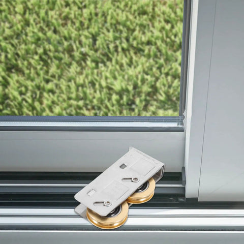 Heavy Duty Sliding Door Window Pulley Replacement Set Featuring Smooth Glide Dual Copper Wheels resting on a track with green grass background.