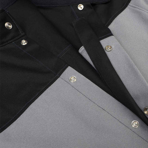 Close-up of Tough As Nails Welding Jacket With Dual FR Fabric Construction showing gray panels and black cotton