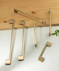 Classic 10 Pack Cabinet Pull Handles for Kitchen and Bedroom Cabinets in Champagne Bronze Finish, displayed on a table, 5 Inch Center To Center Screw Spacing, Solid Zinc Alloy Construction, Easy To Install.