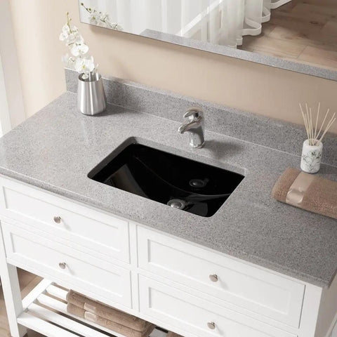 Black Rectangular Porcelain Undermount Sink With Chrome Pop Up Drain Deeply Arched Basin Safe Overflow Vitreous China Construction Built To Last For Modern Vanity Tops And Easy Cleaning shown in a bathroom setting.