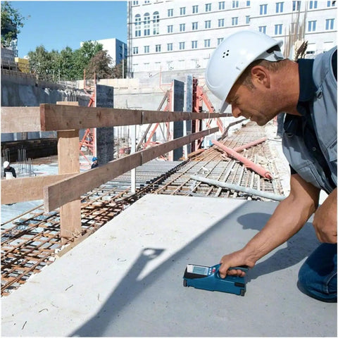 Nail Your Next Home Project Straight Up With This Hella Reliable Wall Scanner And Metal Detector used by a contractor scanning concrete.