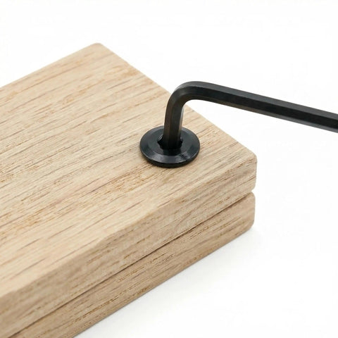 Top Shelf Black Chicago Screws And Binding Post Tools For Leather Crafting And Scrapbook Binding M4 X 8mm Carbon Steel Fasteners and hex wrench on wood.