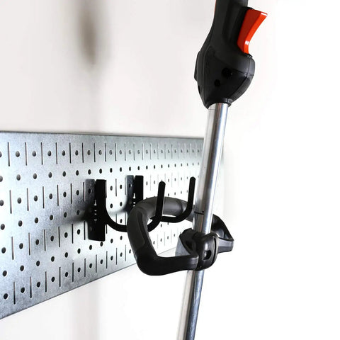 Store Your Gear With This Knockout Galvanized Steel Pegboard Wall Mount Kit For The Garage Featuring Rock Solid Heavy Duty Hooks For Lawn Garden Equipment No Sweat Install, showing lawn tool hung on hooks.