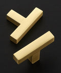 Top Shelf Brushed Gold Cabinet Handles Hella Sturdy Single Hole Drawer Pulls Two Inch Long Solid Zinc Hardware No Nonsense Thirty Pack on black surface.