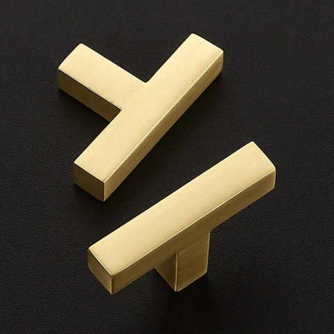 Top Shelf Brushed Gold Cabinet Handles Hella Sturdy Single Hole Drawer Pulls Two Inch Long Solid Zinc Hardware No Nonsense Thirty Pack on black surface.