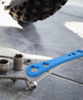 Heavy Duty Oil Drain Screw Removal Tool And 30mm Hexagonal Socket Wrench For Cars on a tiled floor next to socket wrenches.