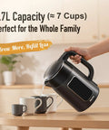 Person pouring from Electric Kettle 1.7L With Clear Touch Screen Temperature Control, No Plastic Contact With Water, Six Preset Temperatures For Tea Coffee Baby Formula, Keep Warm Up To Two Hours, Auto Shut Off, Dark Grey into cups.