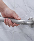 Close-up of a hand gripping the Super Sturdy 24 Inch Stainless Steel Shower Grab Bar That Actually Holds Tight.