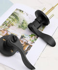 4 Pack Black Wave Style Privacy Door Handles With Lock for bedroom and bathroom interior doors on open decorative book
