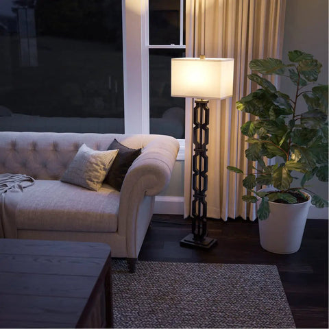 Tall Black Floor Lamp With White Rectangular Shade, 59.5 Inch Height, beside a sofa in a cozy living room setting