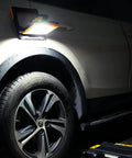 Cordless LED Work Light Compatible With Dewalt And Milwaukee 18V 20V Batteries illuminating car wheel at night