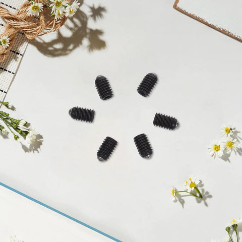 50 Piece M4x6 Stainless Steel Hex Ball Plunger Set Screws tough as nails on a white surface with flowers.
