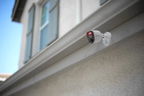 Add On 4K Security Bullet Cam With Flashing Lights And Sensor Spotlight For Indoor Or Outdoor Use, mounted on building exterior