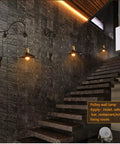 Premium Vintage Wall Sconce Crafted From Solid Wrought Iron Pulley System on stairway wall, adding industrial charm.