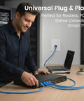 Person connecting Cat 6 Ethernet Cable Pack 50 Pack 1 Ft Cat6 Patch Cables 10 Gbps to networking device for high performance use.