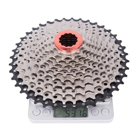 Eight To Twelve Speed Road And Gravel Bike Cassette Freewheel, 11-25 To 50T Range, shown on scale indicating weight