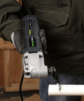 Person using Powerful 2.4 Amp Oscillating Multi Tool Kit With Six Variable Speeds And Quick Lock Accessory Change for pipe cutting
