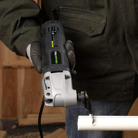 Person using Powerful 2.4 Amp Oscillating Multi Tool Kit With Six Variable Speeds And Quick Lock Accessory Change for pipe cutting