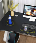 Solid Multifunction Computer Desk With Nifty Cable Management Hole Ergonomic Arched Edge Compact Gaming Workstation Total Game Changer For Tiny Rooms Waterproof Black Surface 47 Inches Wide with water bottle and keyboard.