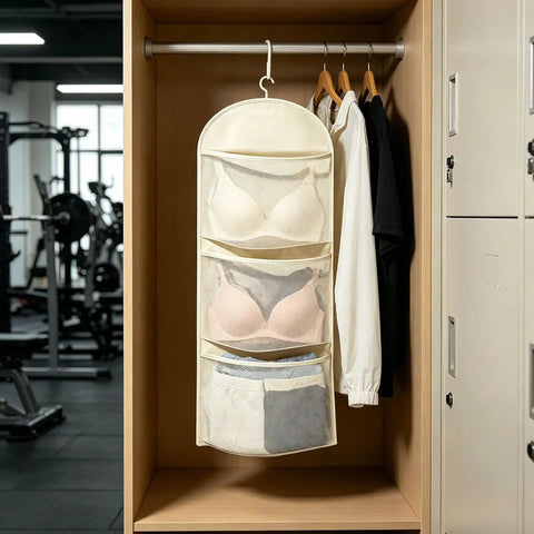 Compact Triple Tier Hanging Closet Organizer With Airy Mesh Pockets Ideal For Bras Bottoms And Socks in a closet setting.
