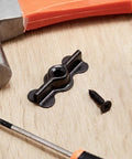 Rock Solid Black Double Wing Flush Mounting Clips With Phillips Screws 24 Piece Kit Made From Hardened Alloy Steel on a wooden surface.