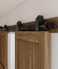 Heavy Duty 10Foot Sliding Barn Door Hardware Kit Featuring Buttery Smooth Silent Rolling Nylon Track System With Knockout 330 Pound Load Capacity For Quick DIY Home Makeovers In Matte Black mounted on a wooden door.