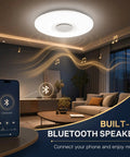 Dimmable 15 Inch LED Ceiling Light With Bluetooth Speaker, 24W, App Control Via Smartphone, Flush Mount Bedroom Fixture shown illuminated in living room.