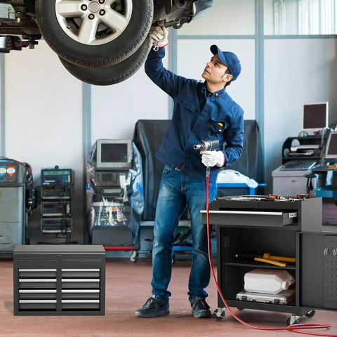 Mechanic using Five Drawer Rolling Tool Chest With Removable Tool Cabinet And Sliding Metal Organizer in garage with car lifted.