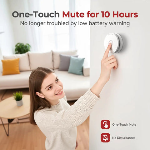 Woman using one-touch mute feature on heavy duty smoke detector with 9V replaceable battery for easy operation.
