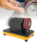 Solid Mini Bench Grinder With Adjustable 2000 To 6000 Rpm Dial For 18V Battery Packs showing rubber feet and dual discs for sharpening.
