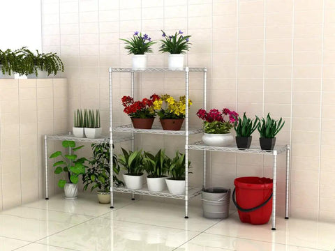 Totally Built Different Five Tier Metal Storage Rack Featuring Adjustable Height Wire Shelving For Seriously Heavy Duty Kitchen Office And Hallway Organization With Clean Silver Finish Rated For Massive Loads, displaying potted plants.