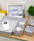 Customizable 8 Pack Felt Drawer Organizer Trays Set For Desk Drawers Shallow Modular Storage Bins For Office Supplies Makeup And Jewelry In Light Gray Mix And Match To Fit Any Drawer Like A Pro on a desk with electronics and greenery.