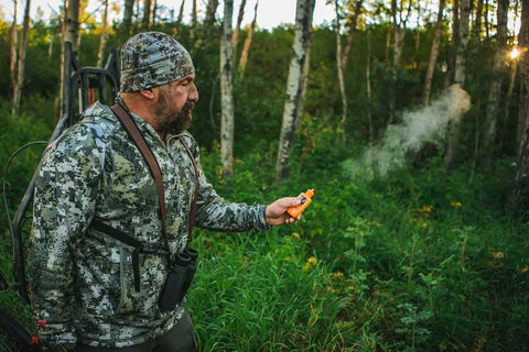Hunter using Long Range Odorless Wind Detector That Sniffs Out Subtle Breezes And Maps Direction Instantly in the forest.