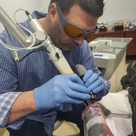 Pro Grade Laser Safety Glasses Serving Up Dead Straight Vision And Knockout Defense Across Two Hundred To Five Hundred Forty Nano Meters Plus Eight Hundred To One Thousand One Hundred For Q Switched Tattoo Removal And Med Spa Treatments Daily worn by technician during laser tattoo removal.