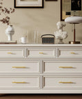 30 Pack Three Inch Hole Center Brushed Gold Stainless Steel Cabinet Handles on a stylish dresser in a modern living space.