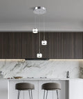 Led Dimmable Three Light Pendant Fixture With Dope Chrome Finish hanging in modern kitchen with marble backsplash