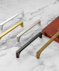 Rock Solid Brushed Gold Cabinet Pulls Kitchen Handles 5 Inch 128mm Centers Heavy Duty Drawer Hardware 10 Pack on marble countertop.